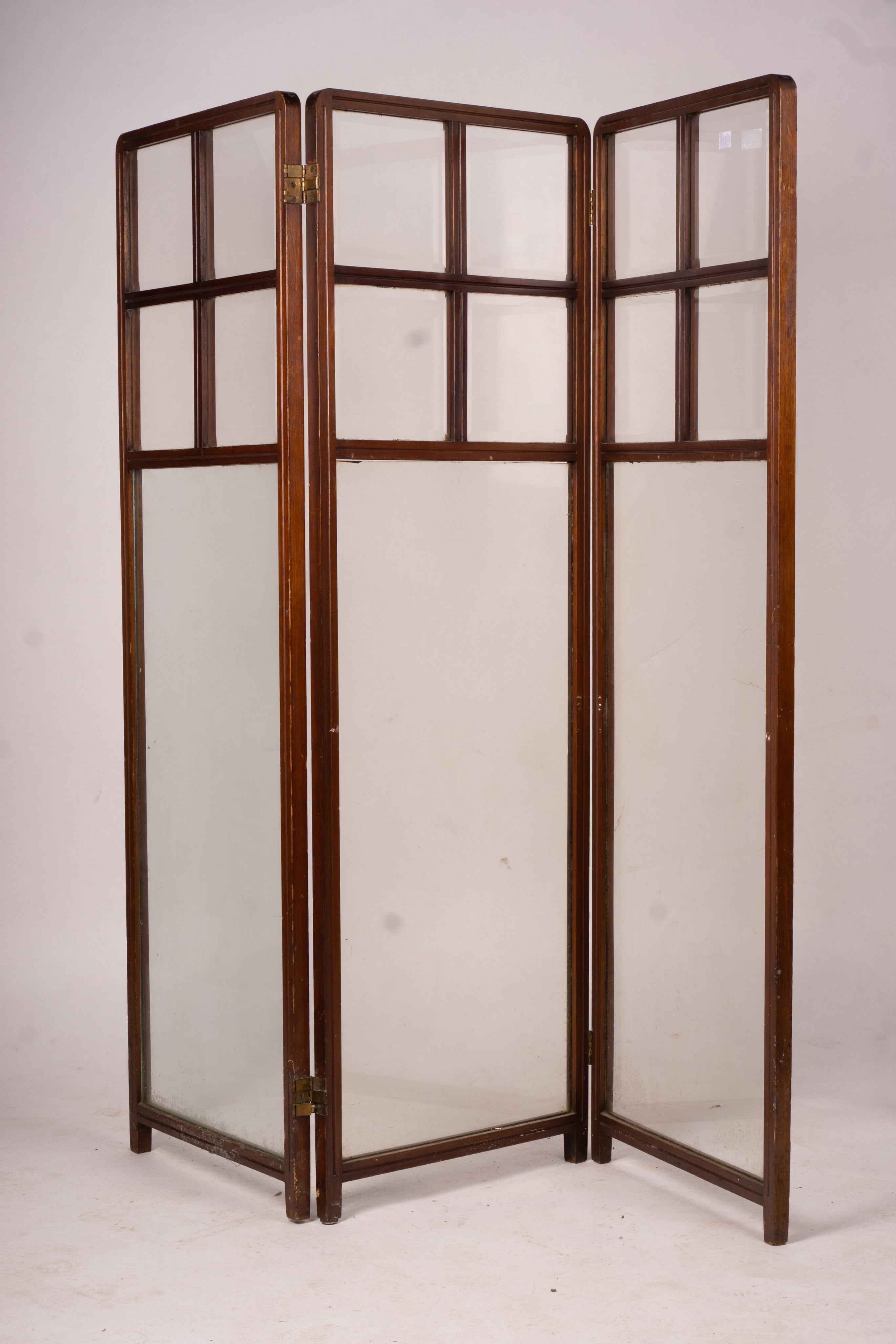 An Edwardian glazed mahogany three fold screen, each panel width 51cm, height 157cm